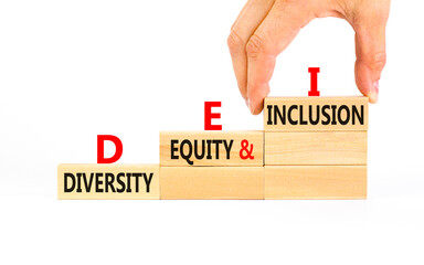 DEI diversity equity and inclusion symbol. Concept words DEI diversity equity and inclusion on blocks. Beautiful white background. Business DEI diversity equity and inclusion concept. Copy space.