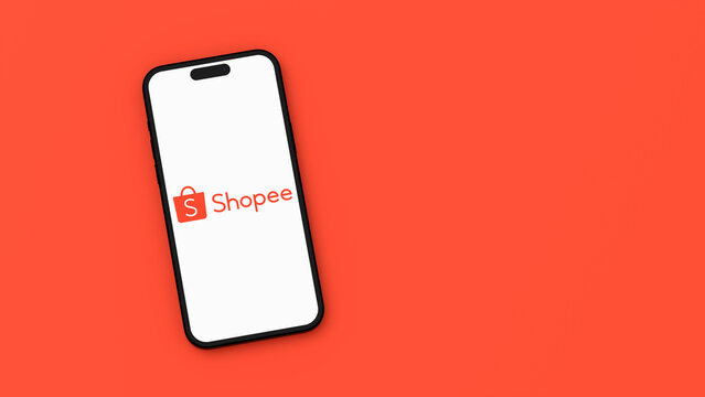 Shopee Logo on Mobile Phone Screen on Orange