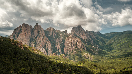 Dark clouds over the Aiguilles de Bavella, needle like rocky mountain peaks surrounded by pine forest and maquis in the centre of Corsica