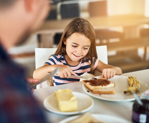 Breakfast, bread and daughter with dad, smile or morning in kitchen, butter and dining table in home. Healthy, father and food of family, child and man in house, eating and bonding with love together