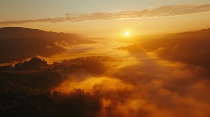 Fototapeta premium A breathtaking sunrise over a misty valley, with soft golden light illuminating the landscape.
