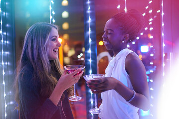Women, friends and cocktail with smile in club, event and happy hour in night. People, nightclub and drink with margarita, alcohol and diversity with celebration, excited and chat at new years party