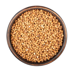 Dry buckwheat grain in clay bowl isolated on white background. File contains clipping path.