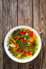 Asparagus soup on wooden table