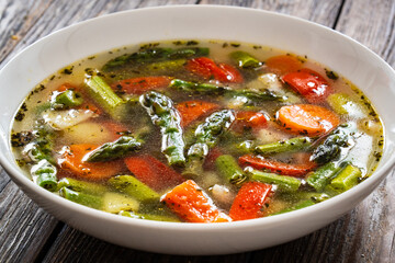 Asparagus soup on wooden table