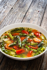 Asparagus soup on wooden table