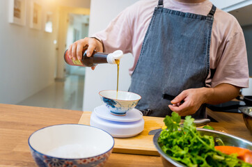 Chef at the kitchen preparing spicy glass noodle salad