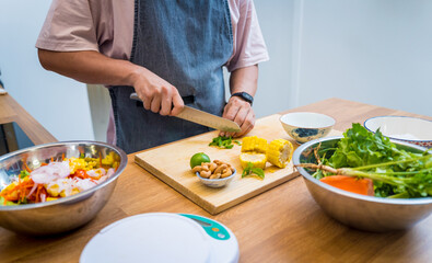 Chef at the kitchen preparing spicy glass noodle salad