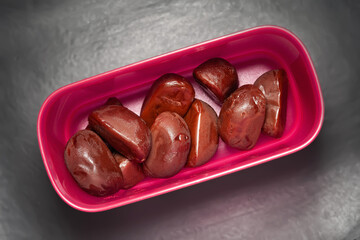 Chocolate candies. Top view of melting chocolate in purple box on a dark