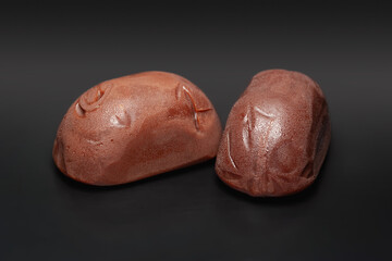 Chocolate candies. Melting chocolate candies on a black