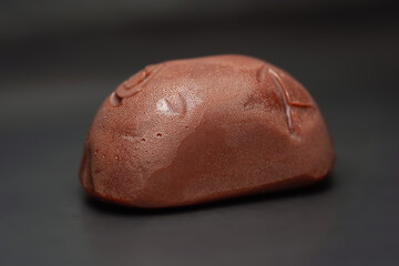 Chocolate candy. Melting candy on a black