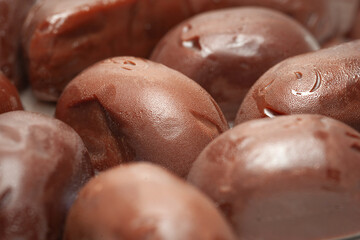 Chocolate candies. A pile of melting chocolates. Selective focus
