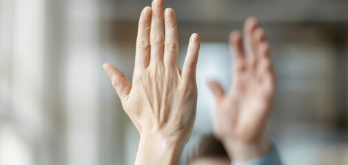 This image captures a young businesswoman giving a high five to her male team member in the office, highlighting a moment of collaboration and achievement.