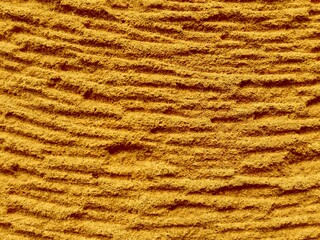 Mustard color sand texture of desert dune. Mustard sand texture for wave beach background. Sea beach golden or mustard sand dune texture in summer. Dune desert waves. Seamless sandy waves background