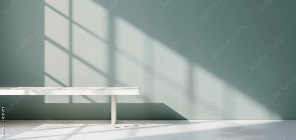 Poster a light blue background highlights a white tabletop, with window shadows on the wall and soft sunlig