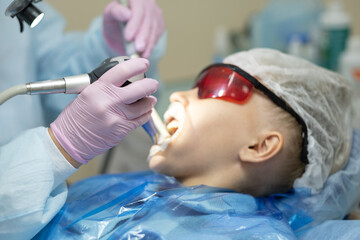 Naklejka premium girl undergoing teeth whitening procedure at the dentist