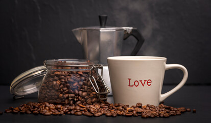 Coffee mug with Love written on it. Coffee pot and mason jar with beans