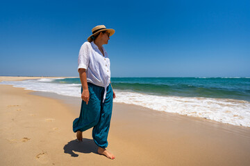 Beautiful woman walking on sunny beach Portugal, Algarve,  praia Armona 

