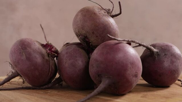  organic beetroots on wooden surface food rotation
