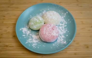 Different color delicious Japanese mochi on the blue plate