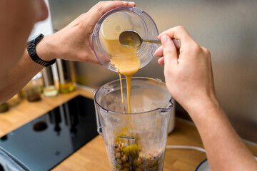 Chef at the kitchen preparing chickpea porridge with ginger