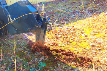 An apparatus for laying fiber optic cables is trencher cable plow tractor