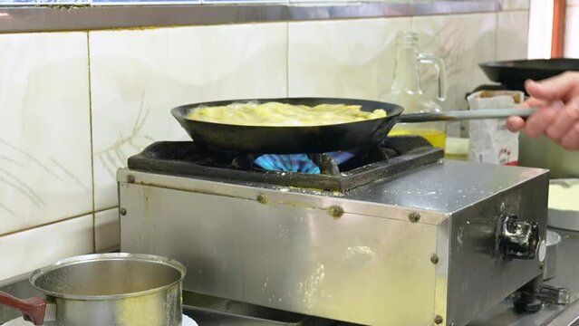 fish frying in oil in a pan