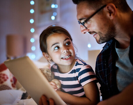 Dad, daughter and tablet in bedroom at night for reading, storytelling and learning on website or ebook app. Child, family and father or man on digital tech at home for paperless education or bonding