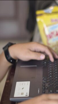 person typing on the keyboard and doing work on a laptop device