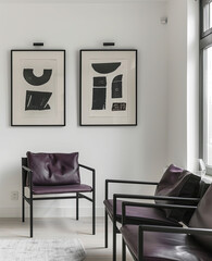 A small framed art print hung on the wall of an apartment in Stockholm. The style was minimalistic with clean lines and simple designs, featuring large white space. The print had a black frame.