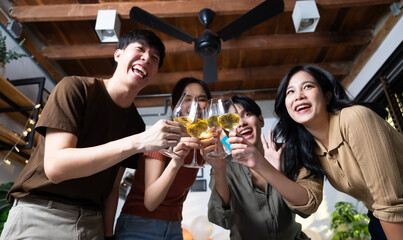Group of young asian people smiling friends drinking at birthday party toast with beer. food and beverag