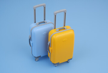 Blue and orange travel suitcases on blue background.