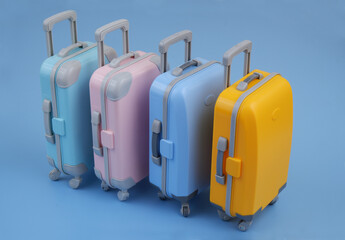 Colorful suitcases on blue background. Travel and vacation concept.