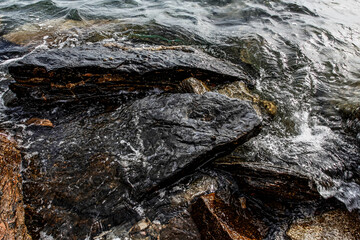 Sea stones on the beach in the sand. Sea landscape. 