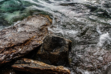 Sea stones on the beach in the sand. Sea landscape. 