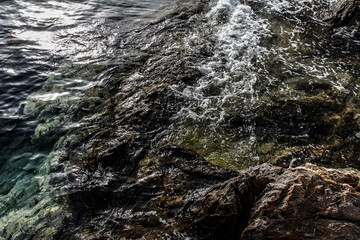 Sea stones on the beach in the sand. Sea landscape. 
