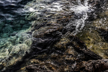 Sea stones on the beach in the sand. Sea landscape. 