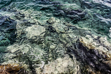 Sea stones on the beach in the sand. Sea landscape. 