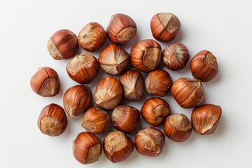 Obraz premium A handful of roasted hazelnuts arranged elegantly on a pristine white surface