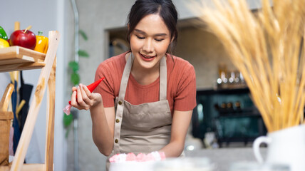 Chef making cake at home. happy relaxing and wellness at home. Young asian woman preparing birthday...