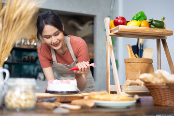 Chef making cake at home. happy relaxing and wellness at home. Young asian woman preparing birthday cake for friends
