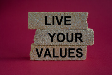 Concept words Live your values on brick blocks. Beautiful pink background. Business, psychological...