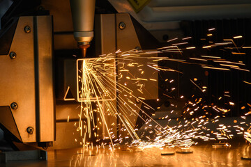 Close up scene the fiber laser cutting machine cut the square shape stainless steel tube with...