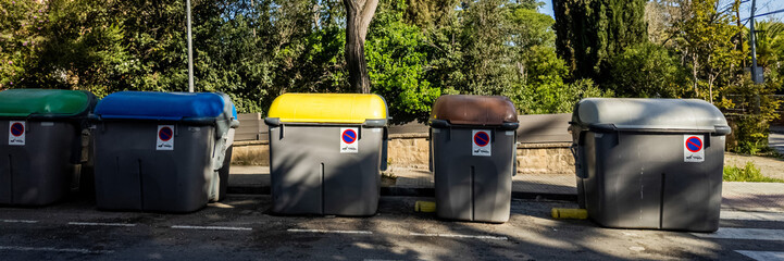 Row of recycling bins for waste segregation in an urban environment, promoting sustainability and...