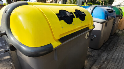 Row of colorful recycling bins in an urban setting, promoting environmental consciousness and waste management, suitable for Earth Day and sustainability themes