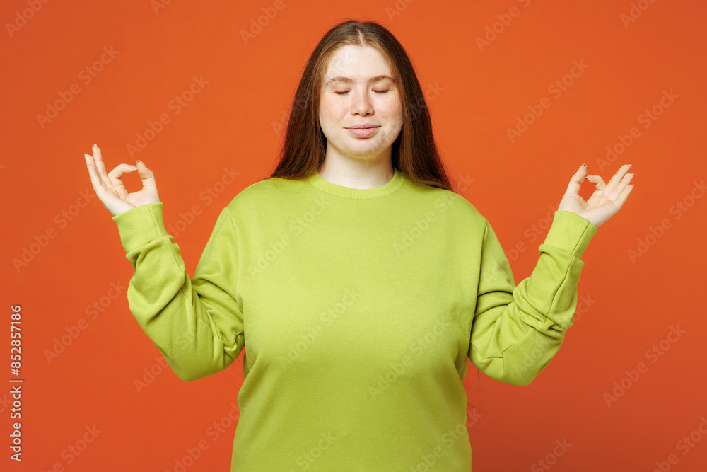 Wall mural young ginger chubby plus size woman wear green sweatshirt casual clothes hold hands in yoga om aum g