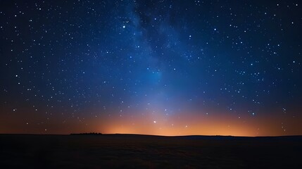 Starry night sky with the Milky Way, viewed from an open field at dusk. There are no light sources but some distant city lights glowing subtly below. Incredibly beautiful, relaxing.