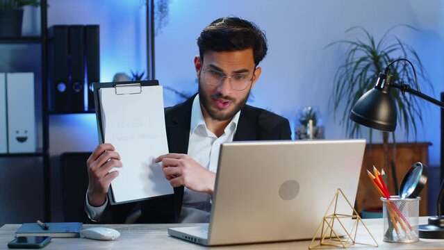 Indian businessman freelancer making online presentation video laptop call education lessons for remote study student classes at office workplace. Male Hindu in suit demonstrates graphic analytics