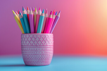 Banner for back to school or kindergarten. A blue ceramic holder filled with colored pencils rests on a colorful pink and purple surface, suggesting creativity and fun in learning.
