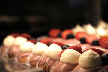 A display case of eclairs. Showcase with desserts.